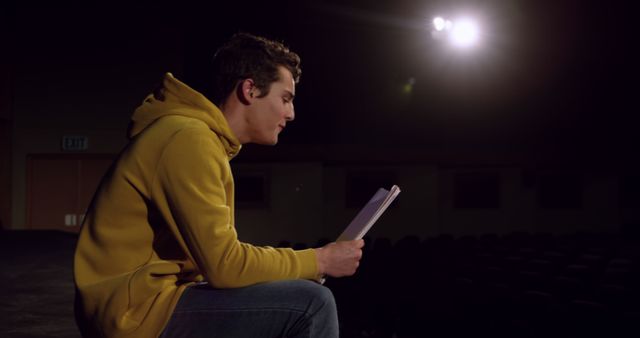 Young Man Rehearsing Lines on Dimly Lit Stage - Download Free Stock Images Pikwizard.com