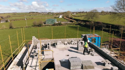 Architect Inspecting Rural Construction Site with Scenic View