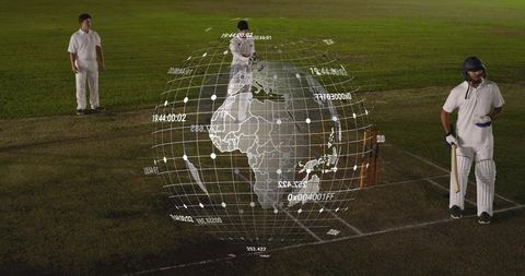 Projecting holographic globe over cricket pitch at night with players in white kit