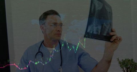 Doctor analyzing x-ray in clinical office with financial chart overlay