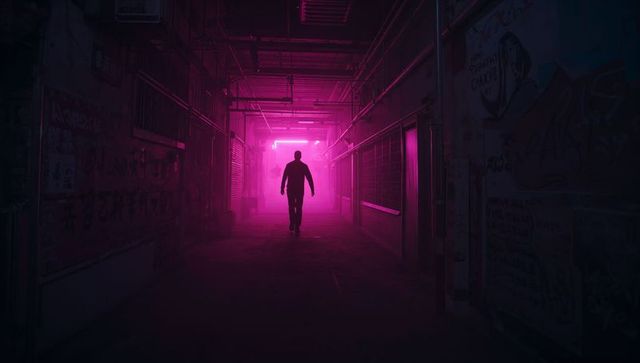 Silhouetted man walking toward magenta neon light in foggy graffiti alley, cyberpunk mood