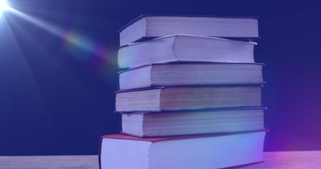 Intriguing image depicting glowing light illuminating a stack of books against a blue background, symbolizing the awareness and celebration of International Literacy Day. Useful for educational and literary ad campaigns, posters, background images for reading and book clubs, as well as educational brochures promoting reading and literature appreciation.