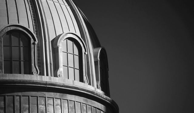 Monochromatic image showcasing detailed architectural features of large dome. Suitable for architecture websites, historical projects, or artistic design references. Perfect for articles on classical architecture or creating mood boards.