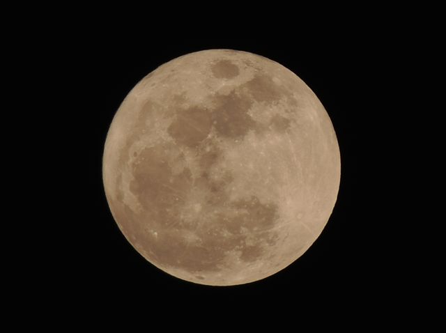 Captivating full moon radiates against dark night sky. Ideal for themes on astronomy, space exploration, night-time photography, lunar phases, science education, or backgrounds for mystical and natural designs.