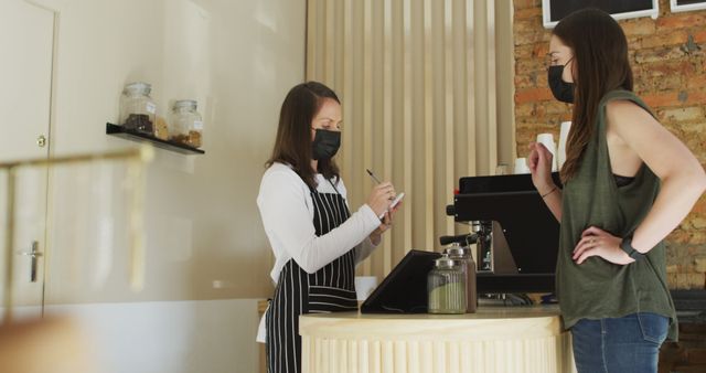 Barista Taking Order While Customer Wearing Mask at Café - Download Free Stock Images Pikwizard.com