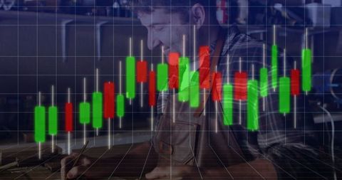 Craftsman Working in Workshop with Overlay of Financial Charts