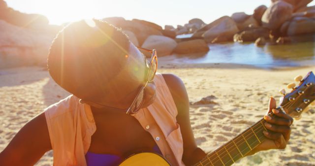 Seaside Guitar Playing in Sunset Glow - Download Free Stock Images Pikwizard.com