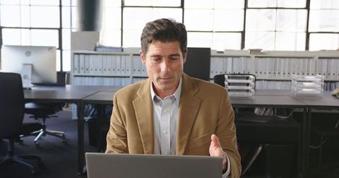Professional man engaged in online meeting in corporate office