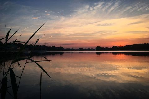 Cover background serene lake at sunset with dramatic sky and reflections