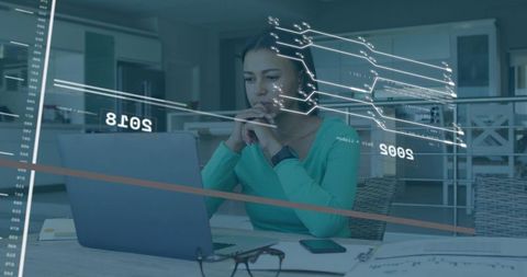 Remote data analyst working on laptop with virtual charts, smartwatch and home workspace