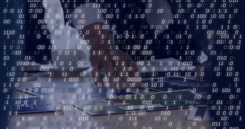 Business team reviewing analytics reports and pointing at tablet with binary overlay