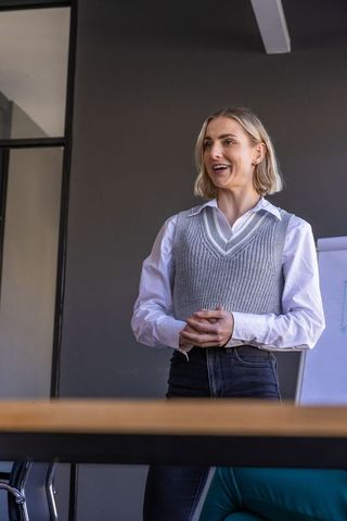 Confident businesswoman leading discussion in modern office