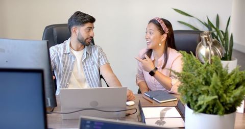 Colleagues Discussing Project in Modern Office Workspace