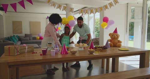 Diverse Family Celebrating Birthday with Cake and Balloons