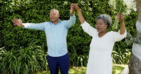 Joyful senior couple celebrating intimate garden wedding