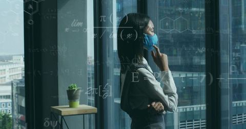 Professional Woman Contemplating at Office Window with Scientific Overlays