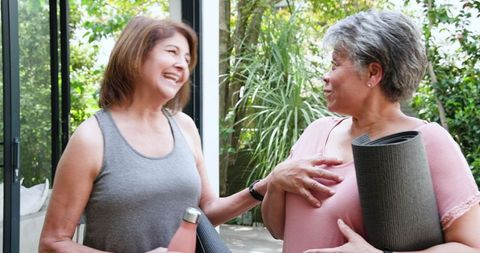 Senior Women Enjoying Yoga Session Conversation Outdoors