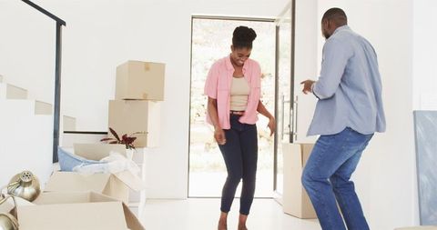 Happy Couple Dancing During New Home Move-In Celebration
