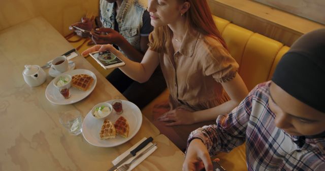 Friends Enjoying Breakfast Waffles in Cafe Using Smartphones - Download Free Stock Images Pikwizard.com