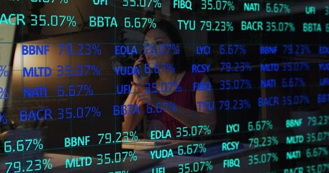 Midadult woman analyzing stock market data on phone with glowing financial tickers