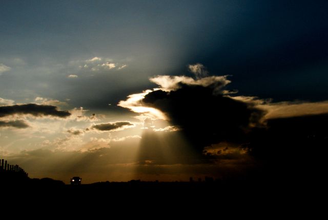 Dramatic Sunset Lighting Up Dark Clouds on Horizon - Download Free Stock Images Pikwizard.com