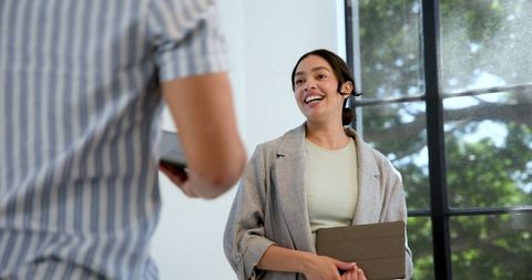 Confident Businesswoman Presenting in Modern Office Environment