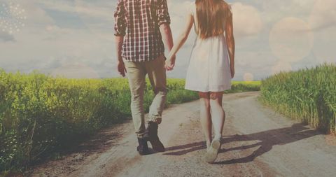 couple holding hands walking on rural pathway at sunset - Download Free Stock Images Pikwizard.com