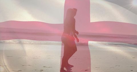 Woman enjoying sunny beach walk with national flag overlay