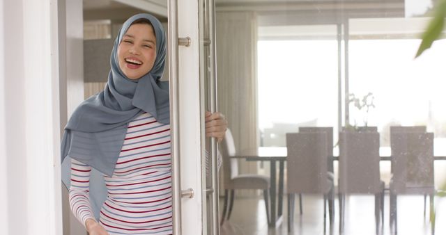 Smiling Woman Wearing Hijab Entering Modern Home - Download Free Stock Images Pikwizard.com