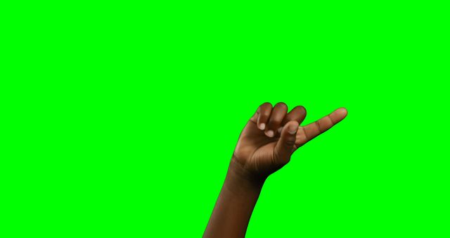 Hand showing a pinky finger extended on a vibrant green screen background. This can be used for designs requiring isolated gestures, communication symbols, or sign language representations. Suitable for various creative projects, including advertisements, educational materials, and visual expressions of concepts.
