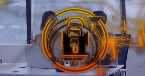 Two Women Discussing Cybersecurity with Holographic Padlock Overlay in Modern Office