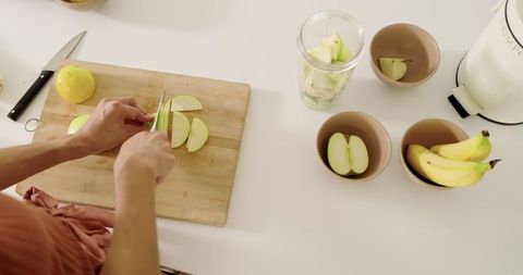 Top-view slicing fresh green apple for healthy recipe