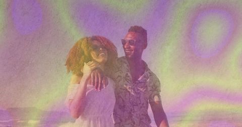 Carefree Couple Enjoying Vibrant Beach Walk in Summer Sun