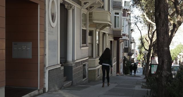 Person Walking on Quiet Residential Street with Historic Buildings - Download Free Stock Images Pikwizard.com