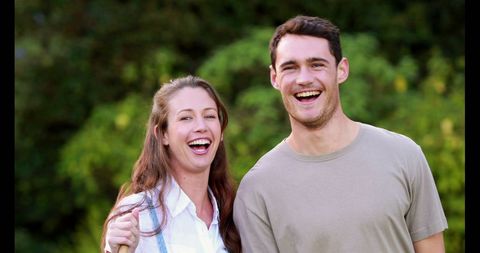 Joyful Young Couple Smiling Outdoors Embracing
