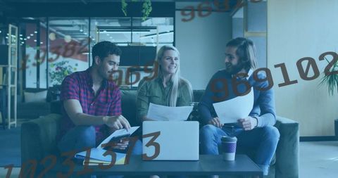 Team Collaborates in Modern Office Lounge Discussing Documents