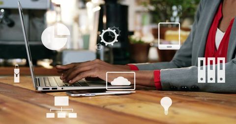 Business woman typing on laptop with cloud icons in coworking workspace for productivity
