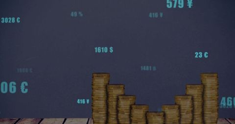 Stacked gold coins forming ascending bar chart on wooden tabletop with cyan currency data