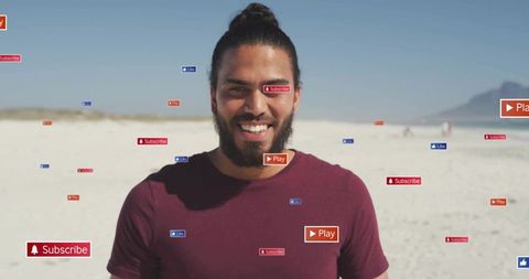 Smiling creator standing on beach with floating subscribe play like icons for social media
