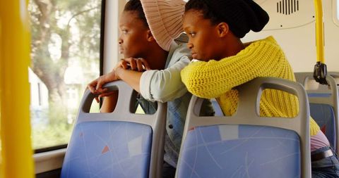 African American Twin Sisters Contemplating on Bus Ride