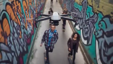 Drone filming skateboarders in graffiti tunnel capturing close-up urban action and street art