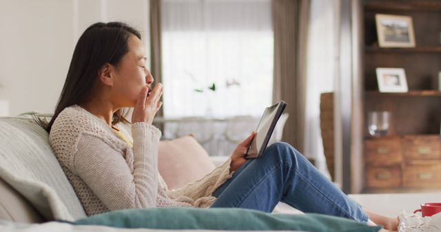 Image of happy asian woman resting on sofa with tablet. Leisure, relax, spending time at home with technology concept.