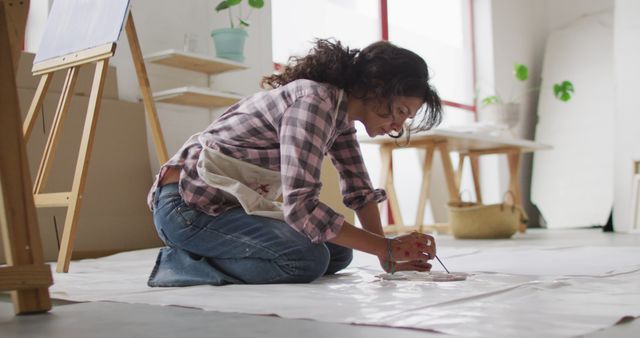 Young Woman Painting on Floor in Art Studio - Download Free Stock Photos Pikwizard.com