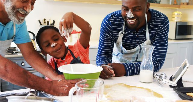 Family engaging in fun and playful baking activity in a modern kitchen. Ideal for promoting family time, cooking lessons, culinary marketing, and kitchen product advertisements.