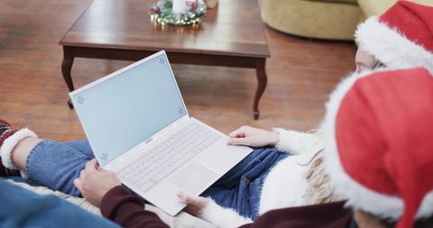 Couple Enjoying Christmas Break on Laptop with Blank Screen