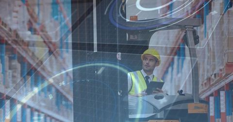 Forklift operator managing inventory with tablet in modern warehouse