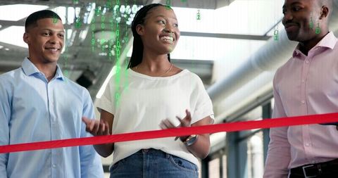 Woman leading ribbon cutting ceremony at tech office celebrating startup launch