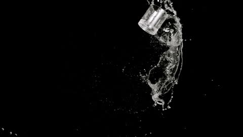 Floating Glass with Splashing Water on Black Background