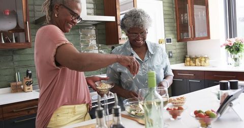 Senior African American Women Enjoying Meal Preparation in Modern Kitchen