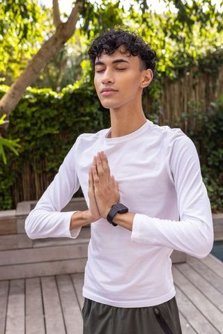 Calm Man Meditating on Backyard Deck
